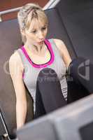 Fit woman using leg press