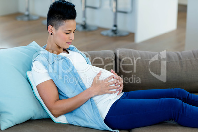 Pregnant woman relaxing on sofa Pregnant woman relaxing on sofa