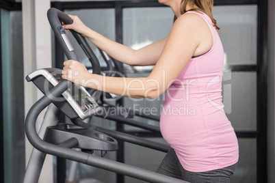 Pregnant woman on crosstrainer