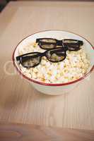 3D glasses in bowl of popcorn