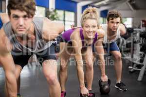 Fitness class lifting dumbbells