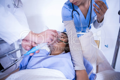 Doctors examining a patient on bed