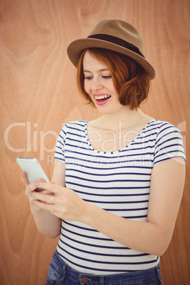 smiling hipster woman on her smartphone