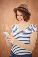 smiling hipster woman on her smartphone