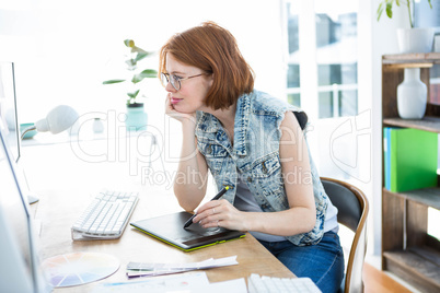 smiling hipster businesswoman writing on a digital drawing table