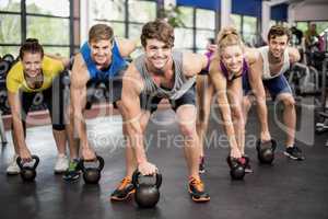 Fitness class lifting dumbbells