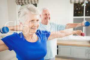 Senior couple performing stretching exercise