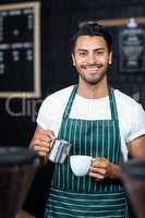 Handsome waiter serving coffee cup