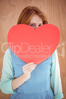 Young hipster holding a red heart shape