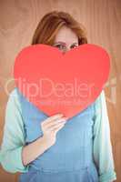 Young hipster holding a red heart shape