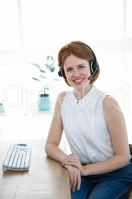 smiling hipster business woman wearing a headset