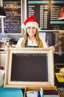 Cute waitress holding a blackboard