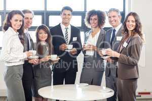 Businesspeople standing together in office