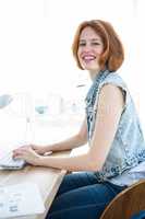 smiling hipster businesswoman sitting at her computer