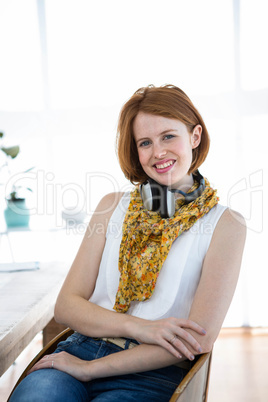 smiling hipster business woman sitting at her desk