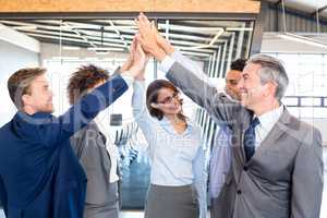 Happy business team high fiving