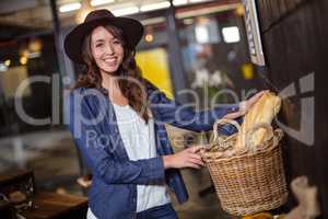 Smiling woman holding bread basket