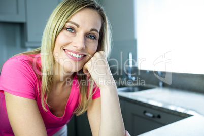 Pretty blonde woman leaning on the counter
