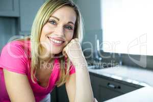 Pretty blonde woman leaning on the counter