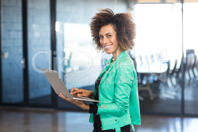 Young woman using laptop in office