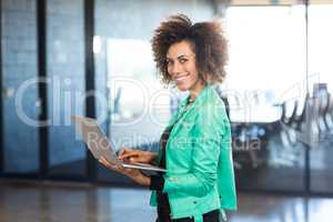 Young woman using laptop in office