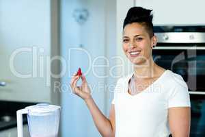 Pregnant woman holding a strawberry