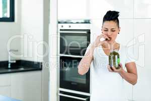 Pregnant woman eating pickles