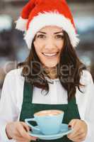 Woman with santa hat holding coffee