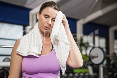 Woman wiping sweat with towel