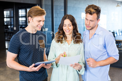 Three confident colleagues discussing in office