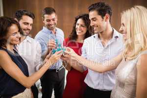 Young and handsome group of friends drinking shots