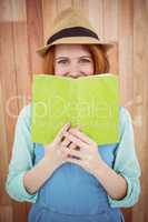 Red haired hipster reading a book