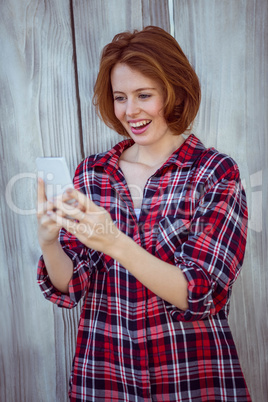 smiling hipster woman on her smartphone