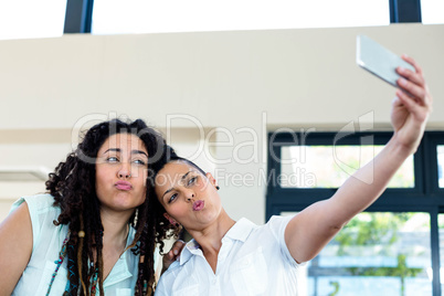 Lesbian couple taking a selfie on phone