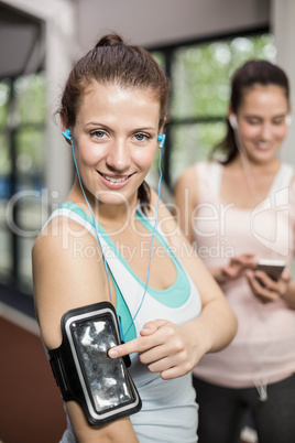 Smiling friends listening to music