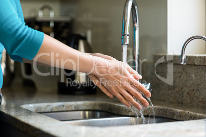 Pretty woman washing her hands