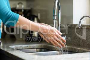 Pretty woman washing her hands