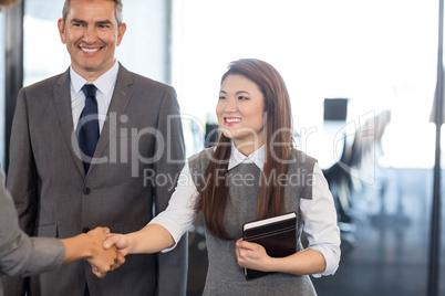 Businesswoman interacting with team in office