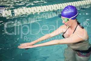 Pregnant woman exercising in the pool