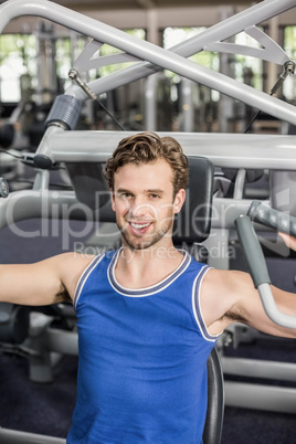 Fit man using weight machine