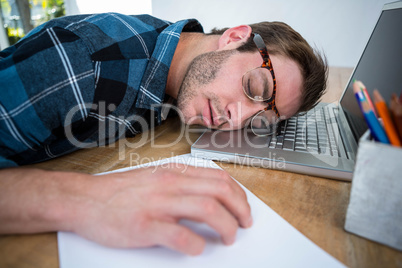 Handsome man sleeping on laptop