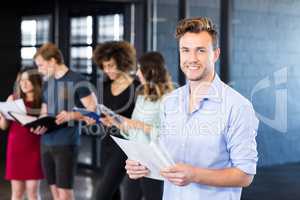 Portrait of smiling man holding a document