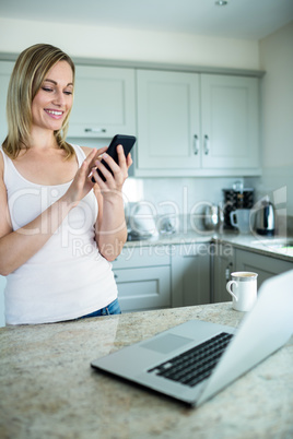 Pretty blonde woman looking at smartphone