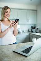 Pretty blonde woman looking at smartphone