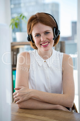 smiling hipster business woman wearing a headset