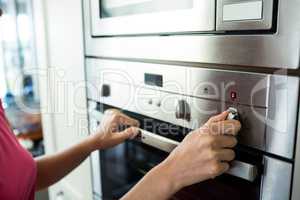 Woman setting up the oven