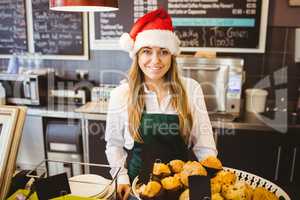 Cute waitress standing behind the counter