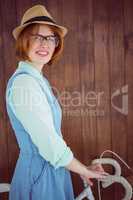 Cute red haired hipster with glasses and a bike