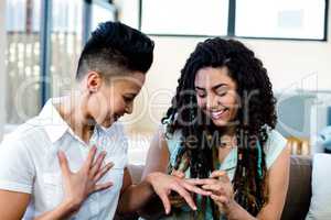 Woman putting a ring on her partners finger