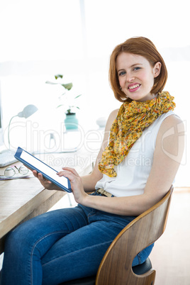 smiling hipster woman on a tablet